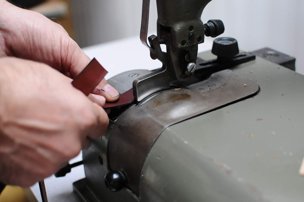 Luxury dog collar being stitched by a Leathersmith for Teddy Maximus